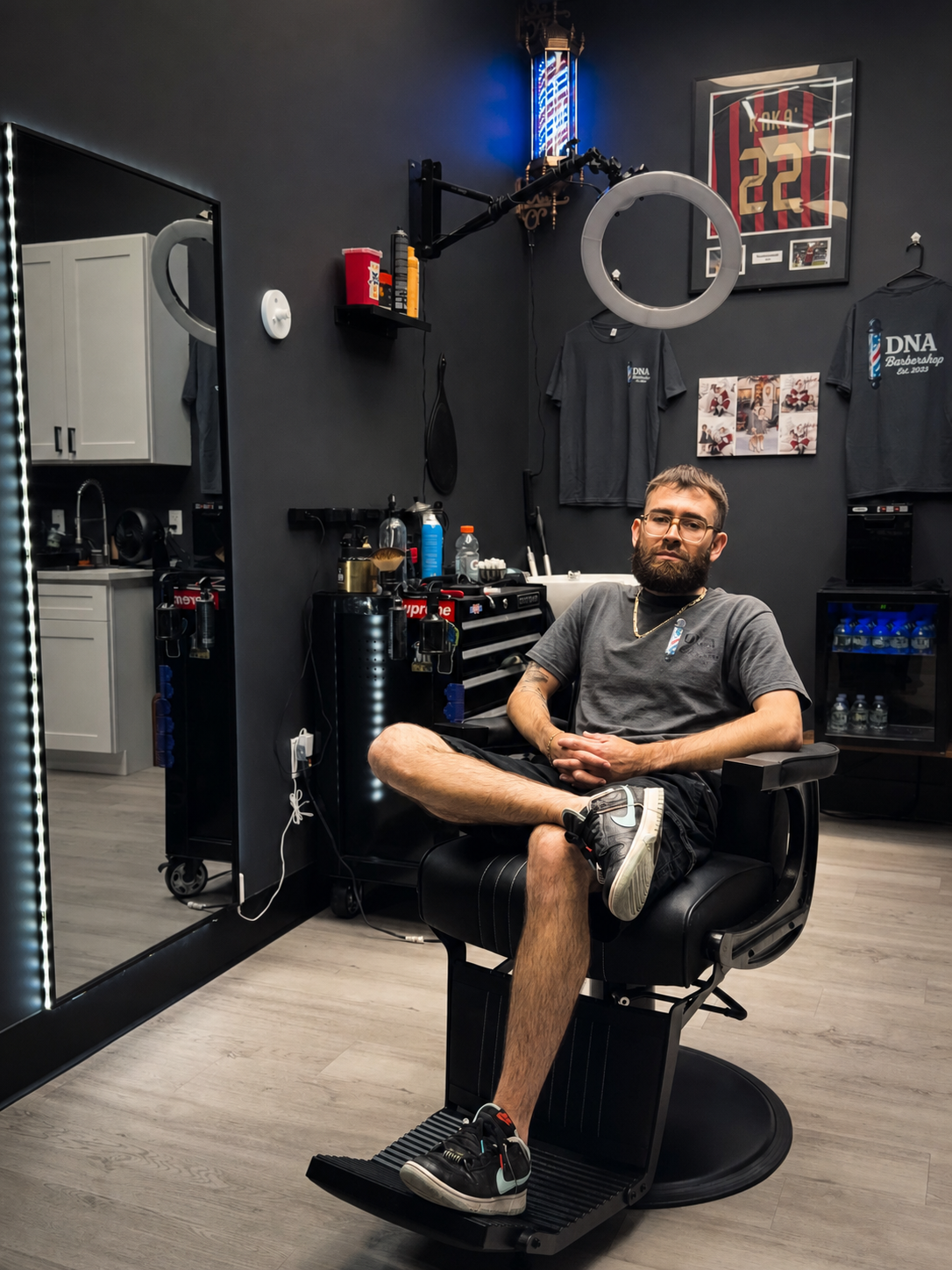 Celin seated in his DNA Barbershop studio