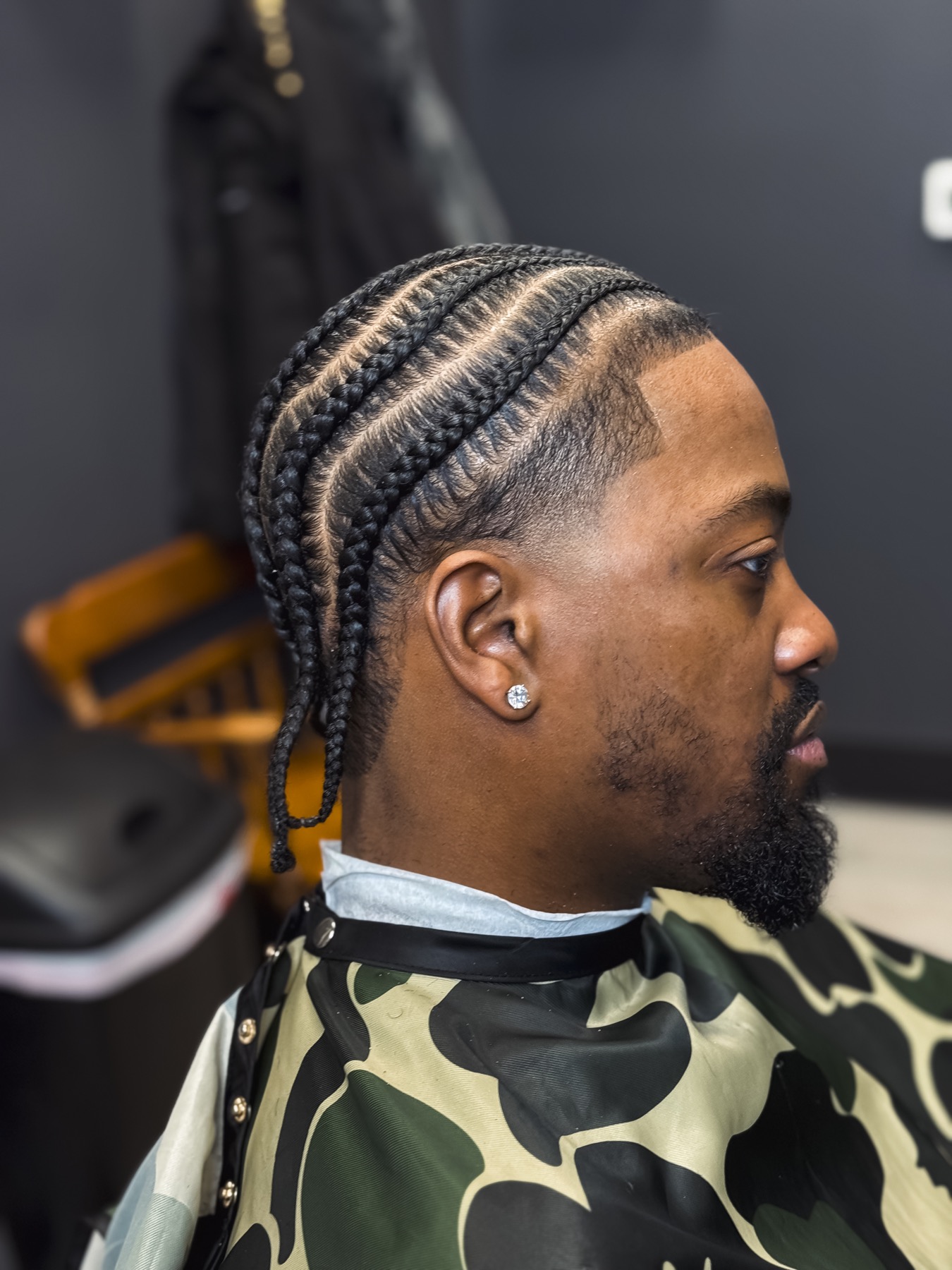 Braids with a clean natural taper by DNA Barbershop